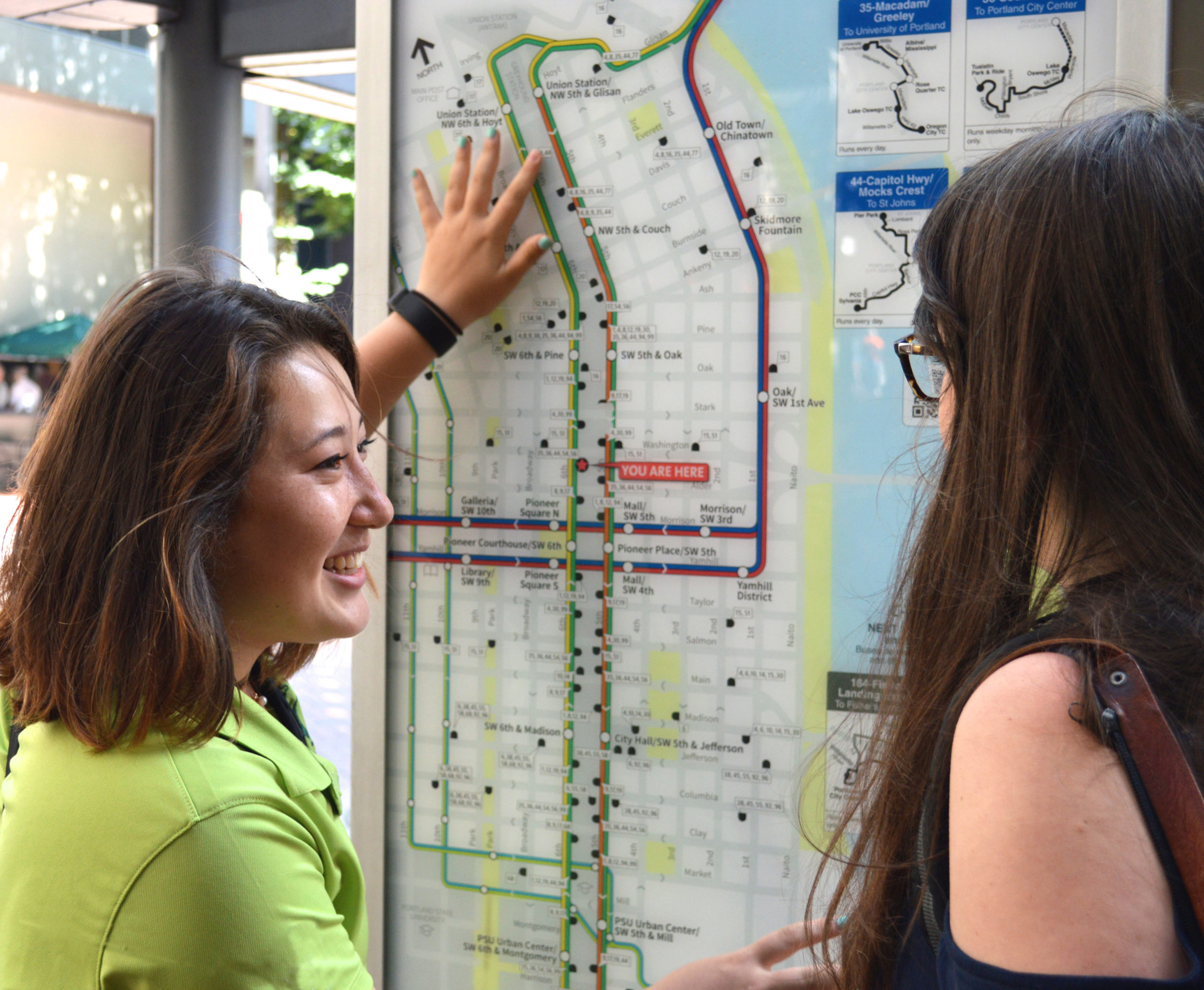 Downtown Portland Clean & Safe Sidewalk Ambassador assists visitor with directions.